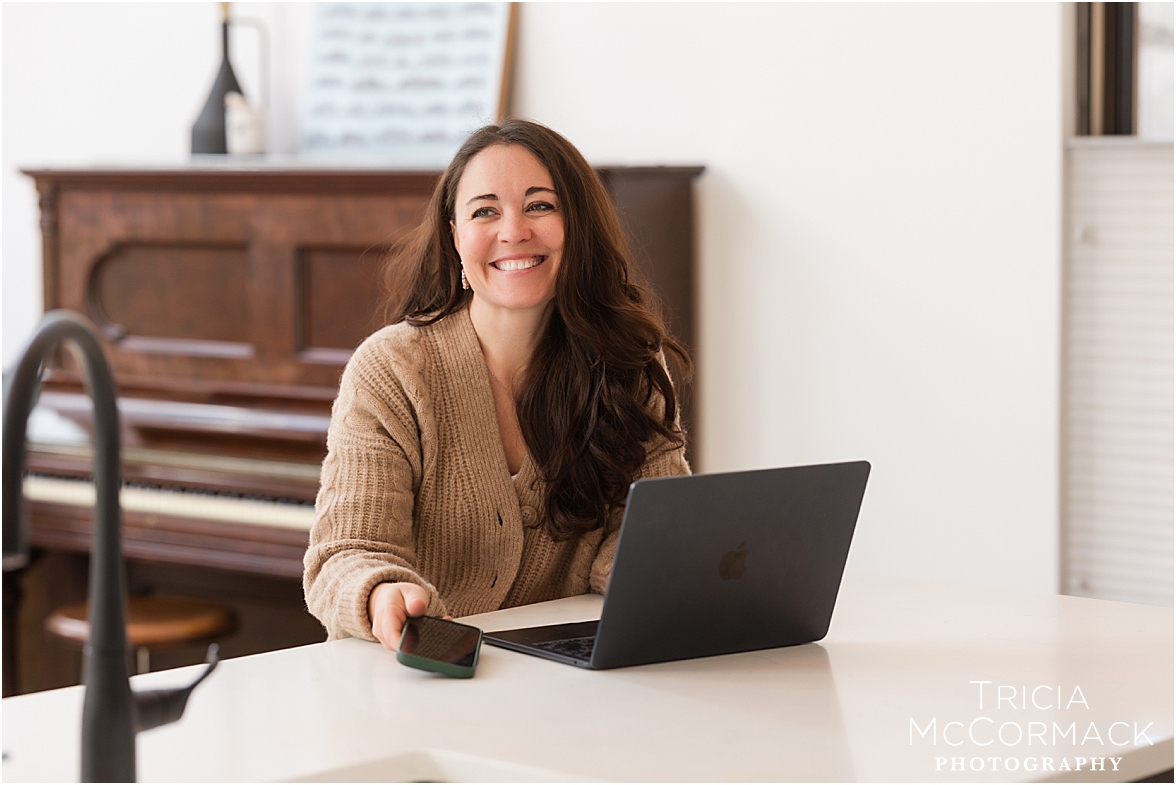 woman with brown hair working on computer