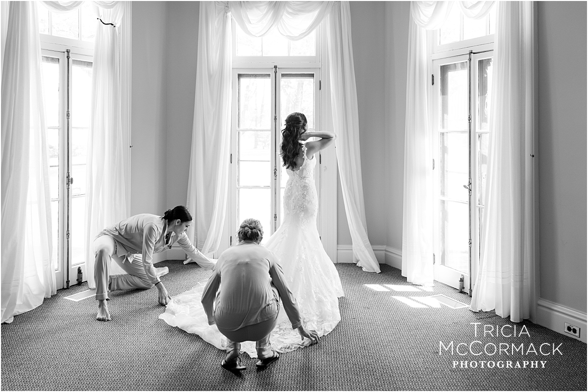 bride puts on her wedding gown