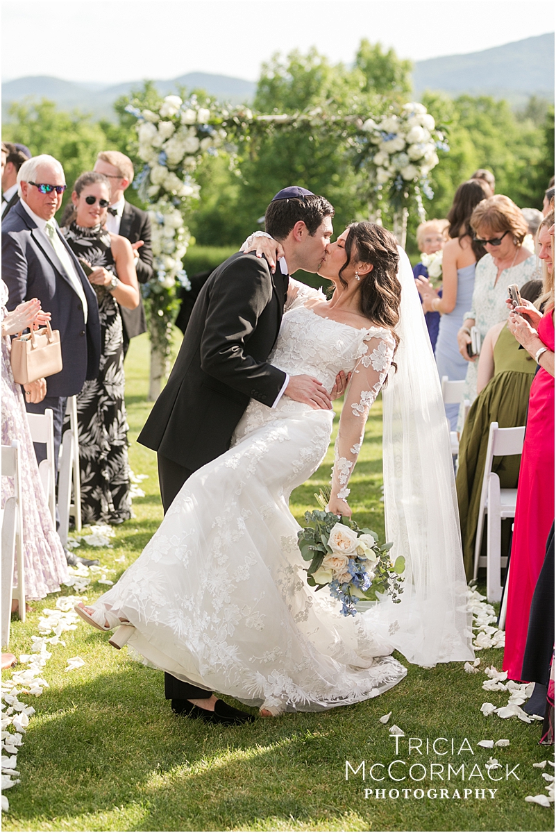 Groom kisses bride after ceremony