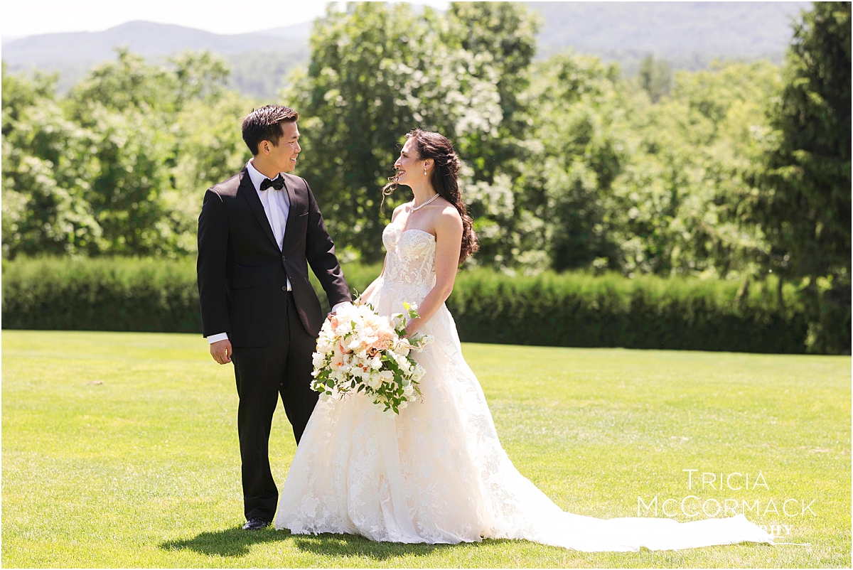 Bride and groom walk hand in hand after their wedding at Tanglewood in The Berkshires